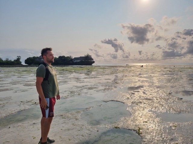 Traveler exploring Zanzibar beach after Bolt taxi ride, extra travel tips